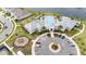 Aerial view of a community pool and clubhouse with ample parking and a nearby playground at 10414 Folly Beach Rd, Orlando, FL 32827