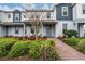 Charming two-story townhome with a welcoming front porch and well-maintained landscaping at 10414 Folly Beach Rd, Orlando, FL 32827