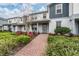 Charming two-story townhome with a welcoming front porch and well-maintained landscaping at 10414 Folly Beach Rd, Orlando, FL 32827