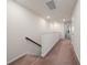Upstairs hallway with carpet, white walls, and access to multiple rooms at 10414 Folly Beach Rd, Orlando, FL 32827