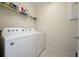Functional laundry area with a washer and dryer and storage shelf at 10414 Folly Beach Rd, Orlando, FL 32827