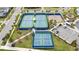 Aerial view of community tennis and basketball courts, surrounded by sidewalks and parking at 10414 Folly Beach Rd, Orlando, FL 32827