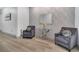 Hallway with elegant gray accent chairs, a glass console table, light gray plank flooring and a decorative mirror at 11454 Wakeworth St, Orlando, FL 32836