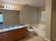 Bathroom features a double sink vanity, toilet, and a large bathtub with tile surround and a window at 138 Inconnu Ct, Kissimmee, FL 34759