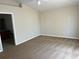 This bedroom is carpeted and has neutral colored walls and a door that leads to an ensuite bathroom at 138 Inconnu Ct, Kissimmee, FL 34759