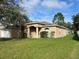 Attractive single-Gathering home featuring stucco siding, arched entrance, and well-manicured lawn at 138 Inconnu Ct, Kissimmee, FL 34759