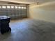 This spacious garage has a concrete floor and a garage door with windows and a recycling can at 138 Inconnu Ct, Kissimmee, FL 34759