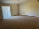 Spacious living room with sliding glass doors allowing plenty of natural light and carpeted floors at 138 Inconnu Ct, Kissimmee, FL 34759