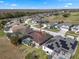 Aerial view of a home and surrounding neighborhood with a golf course nearby at 141 Prestwick Dr, Davenport, FL 33897