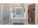 Bathroom with a walk-in shower and a soaking tub under a window with blinds at 141 Prestwick Dr, Davenport, FL 33897