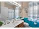 Bright bathroom with a white sink, wood cabinet, and unique blue accent wall at 141 Prestwick Dr, Davenport, FL 33897