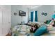 Charming bedroom with two twin beds, blue accents and a flat screen television at 141 Prestwick Dr, Davenport, FL 33897