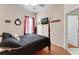Bedroom with a four-poster bed, ceiling fan, and mounted TV at 141 Prestwick Dr, Davenport, FL 33897