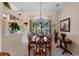 Formal dining room featuring a chandelier, large windows and seating for eight for dinner gatherings at 141 Prestwick Dr, Davenport, FL 33897