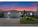 Beautiful home with a three car garage, lawn, and landscaping at 141 Prestwick Dr, Davenport, FL 33897