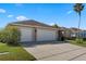 This home boasts a three-car garage with well maintained landscaping, and a spacious driveway at 141 Prestwick Dr, Davenport, FL 33897