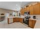 Functional kitchen featuring modern appliances, generous counter space, and wood cabinetry at 141 Prestwick Dr, Davenport, FL 33897