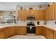 Well-maintained kitchen with sleek appliances, abundant counter space, and wood finish cabinets at 141 Prestwick Dr, Davenport, FL 33897