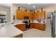 Well-equipped kitchen with ample cabinet space, stainless steel appliances, and bright countertops at 141 Prestwick Dr, Davenport, FL 33897