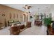 Open-concept living room featuring neutral decor, rattan furniture, and a view into dining area at 141 Prestwick Dr, Davenport, FL 33897