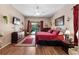 Comfortable primary bedroom features wood floors, a view of the pool, and elegant furnishings at 141 Prestwick Dr, Davenport, FL 33897