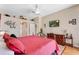 Main bedroom with elegant decor, plush bedding, and an entertainment area with a flat-screen TV at 141 Prestwick Dr, Davenport, FL 33897