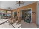 Covered patio with outdoor furniture and ceiling fans for a relaxing entertainment space at 141 Prestwick Dr, Davenport, FL 33897