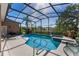 Enclosed pool area featuring a pool, hot tub, deck, and patio furniture at 141 Prestwick Dr, Davenport, FL 33897