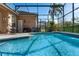 Enclosed swimming pool with a raised spa, patio and outdoor furniture at 141 Prestwick Dr, Davenport, FL 33897
