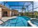 Enclosed pool with an attached hot tub, tile accents and patio space at 141 Prestwick Dr, Davenport, FL 33897