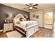 Comfortable bedroom featuring a ceiling fan, hardwood floors, and stylish decor at 151 Lake Arietta Ct, Auburndale, FL 33823