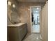 Modern bathroom featuring stylish vanity, mirror, and marble tile, creating a clean and elegant space at 18633 14Th Ave, Orlando, FL 32833