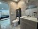 Well-lit bathroom with marble tile, and modern vanity and cabinets, offering a contemporary and inviting space at 18633 14Th Ave, Orlando, FL 32833