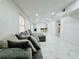 Bright living room with white marble floors, recessed lighting, and a comfortable gray sectional sofa at 18633 14Th Ave, Orlando, FL 32833