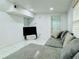 Bright living room with white walls, modern marble floors, and a gray sectional sofa for relaxation at 18633 14Th Ave, Orlando, FL 32833