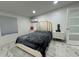 Main bedroom boasting marble floors, neutral wall paint, and a comfortable bed with stylish side tables at 18633 14Th Ave, Orlando, FL 32833