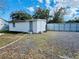 Outbuilding featuring white vinyl siding, a functional door and windows, and a neutral-toned gravel yard at 18633 14Th Ave, Orlando, FL 32833