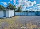 Outbuilding featuring white vinyl siding, a functional door and windows, and a large neutral-toned gravel yard at 18633 14Th Ave, Orlando, FL 32833