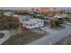 Aerial view of home with nearby waterfront and skyline in distance at dusk at 2061 S Peninsula Dr, Daytona Beach, FL 32118