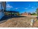 Spacious backyard with a pergola and outdoor dining area, ready for landscaping at 2061 S Peninsula Dr, Daytona Beach, FL 32118