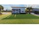 Backyard with a pergola, seating area, and grass, perfect for outdoor relaxation at 2061 S Peninsula Dr, Daytona Beach, FL 32118