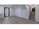 Finished basement showcasing new flooring, door to outside, and staircase at 2061 S Peninsula Dr, Daytona Beach, FL 32118