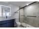 Modern bathroom with a vanity, illuminated mirror, toilet, and glass-enclosed shower at 2061 S Peninsula Dr, Daytona Beach, FL 32118