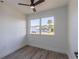 Empty bedroom featuring bright natural light from large window and gray vinyl floors at 2061 S Peninsula Dr, Daytona Beach, FL 32118