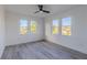 Bright bedroom with three windows and modern gray floors at 2061 S Peninsula Dr, Daytona Beach, FL 32118
