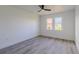 Bright bedroom features new floors, a modern ceiling fan and a window with lots of natural light at 2061 S Peninsula Dr, Daytona Beach, FL 32118