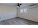 Bright bedroom features a ceiling fan, air conditioner, and wood-look floors at 2061 S Peninsula Dr, Daytona Beach, FL 32118