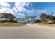 Modern two-story home with a well-manicured lawn and mature trees at 2061 S Peninsula Dr, Daytona Beach, FL 32118