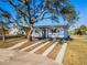 Inviting home exterior with modern landscaping and beautiful mature trees at 2061 S Peninsula Dr, Daytona Beach, FL 32118