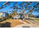 Lovely home showcasing a lush front yard, and mature trees in a serene setting at 2061 S Peninsula Dr, Daytona Beach, FL 32118